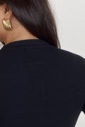 Soft black cotton ribbed bodysuit with polished elevated neckline.