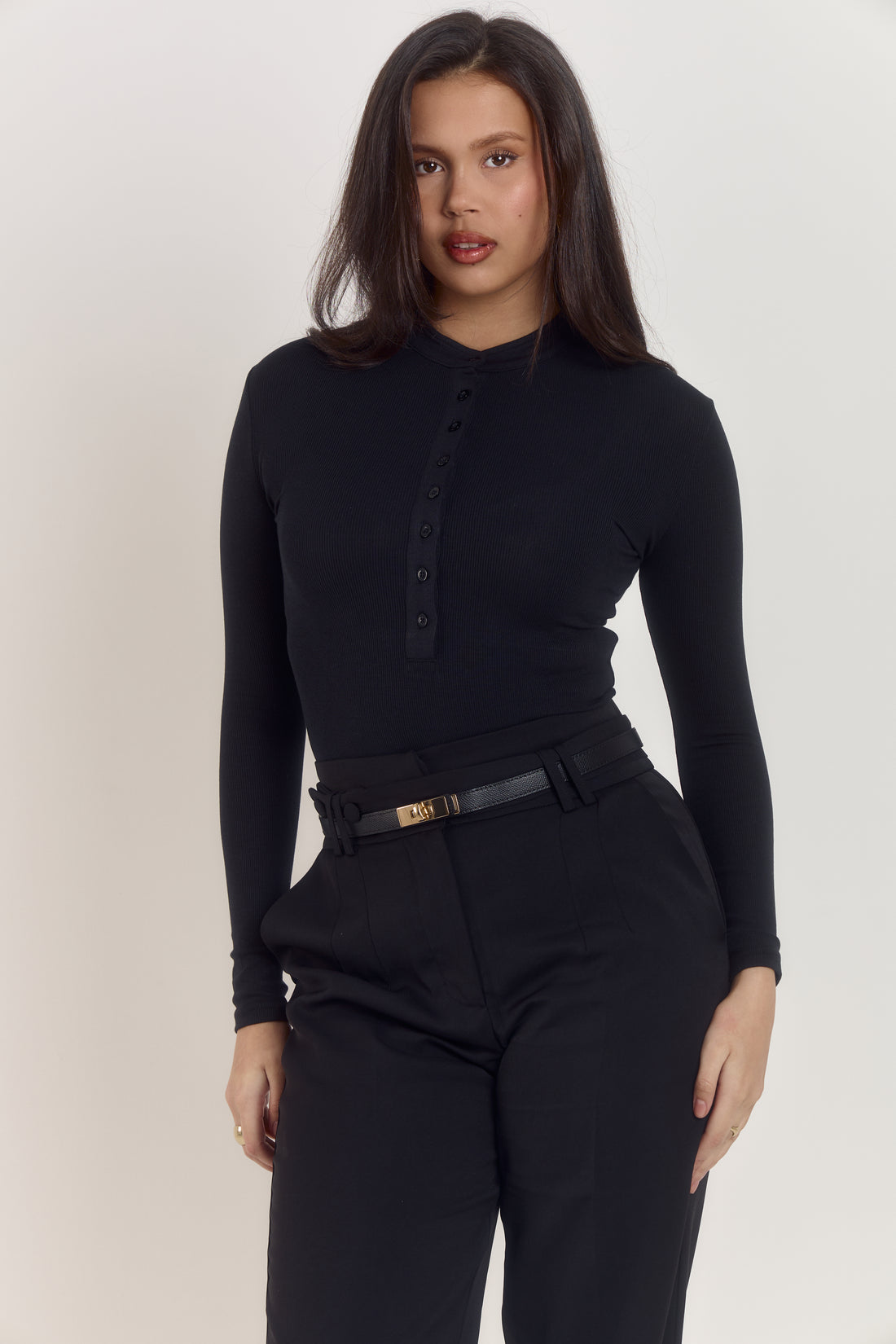Premium black cotton rib long sleeve bodysuit with refined minimal aesthetic.