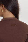 Cocoa brown fitted cotton bodysuit with long sleeves and seamless shaping fit.