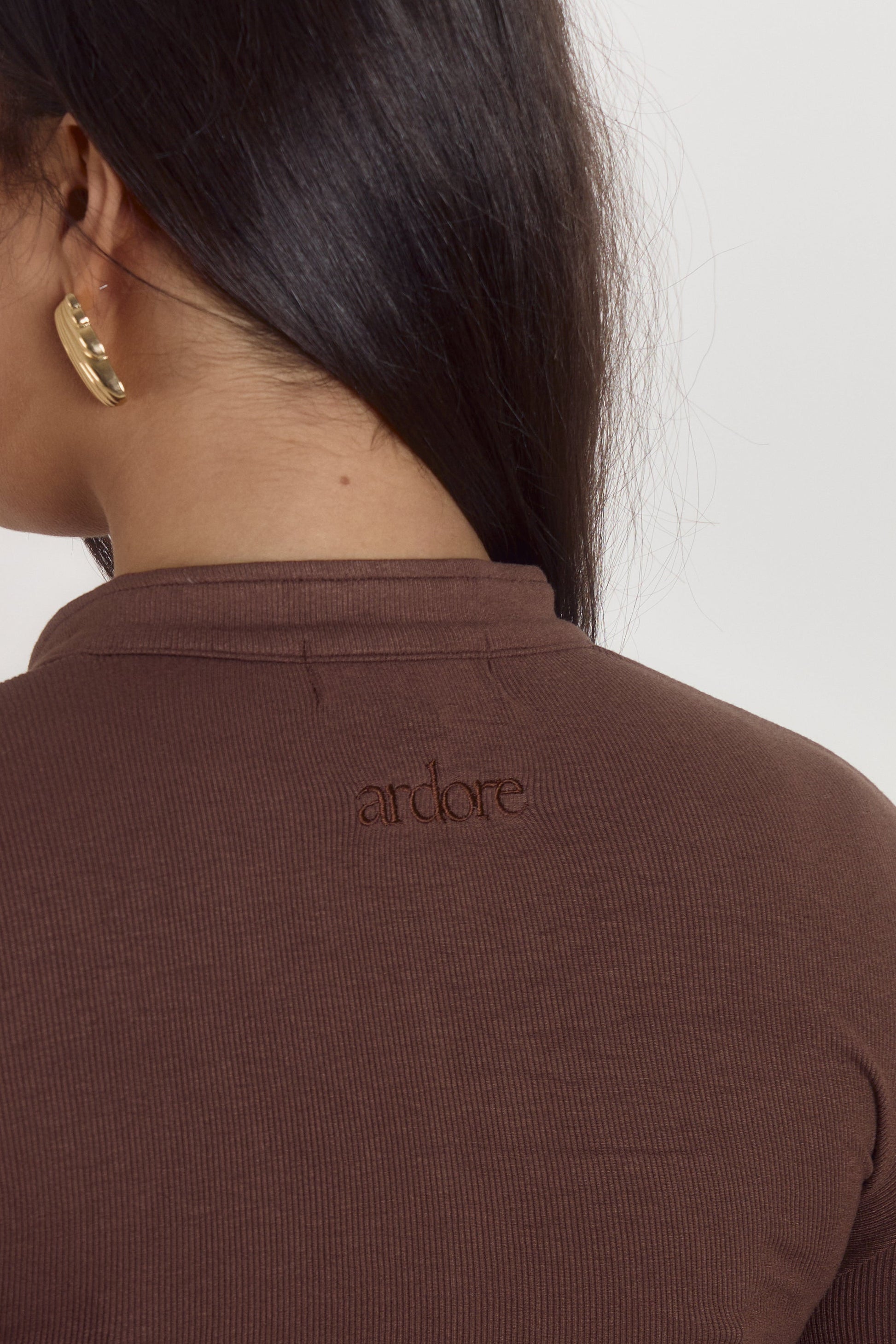 Cocoa brown fitted cotton bodysuit with long sleeves and seamless shaping fit.