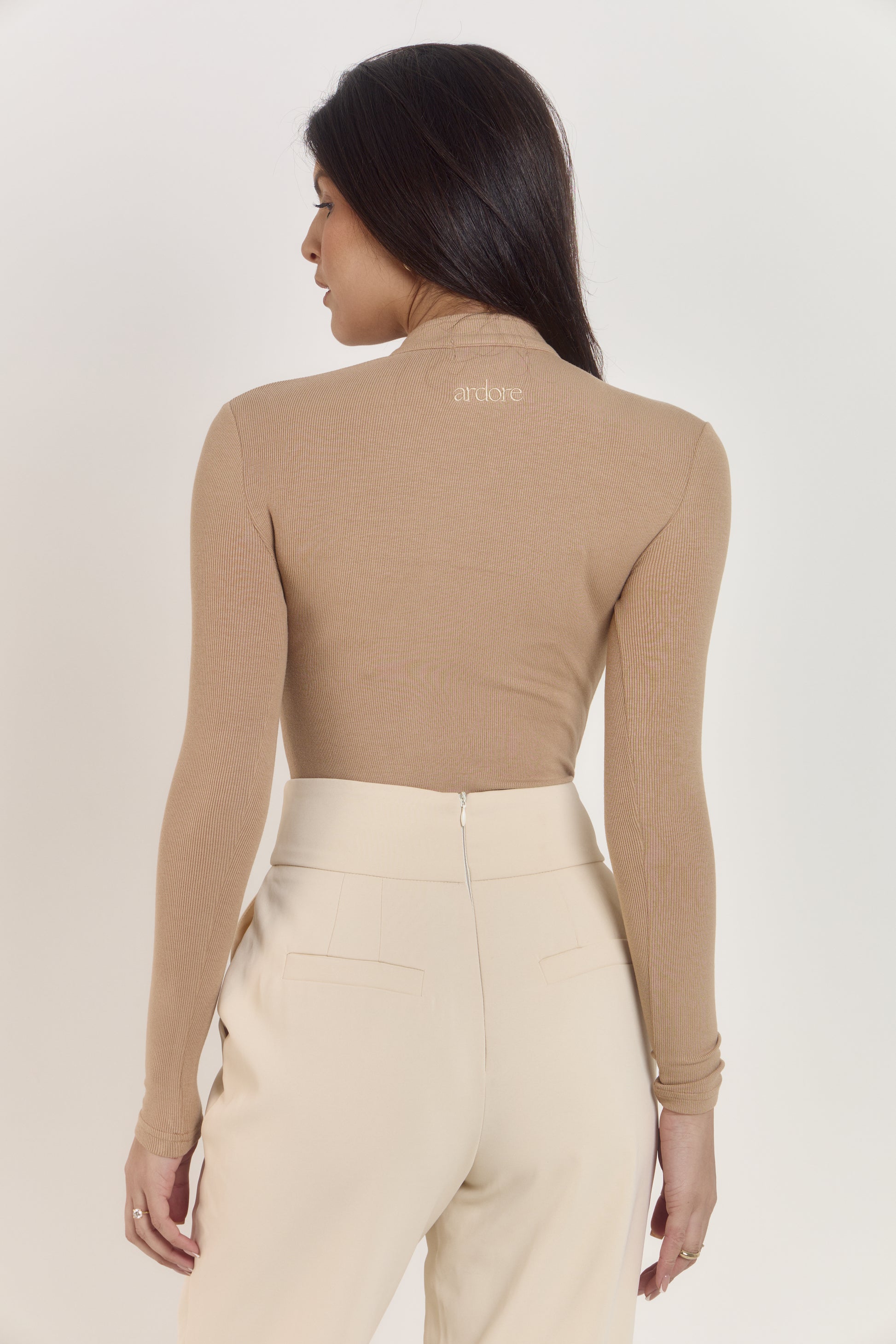 Flattering tan cotton rib Henley style bodysuit styled with tailored trousers.