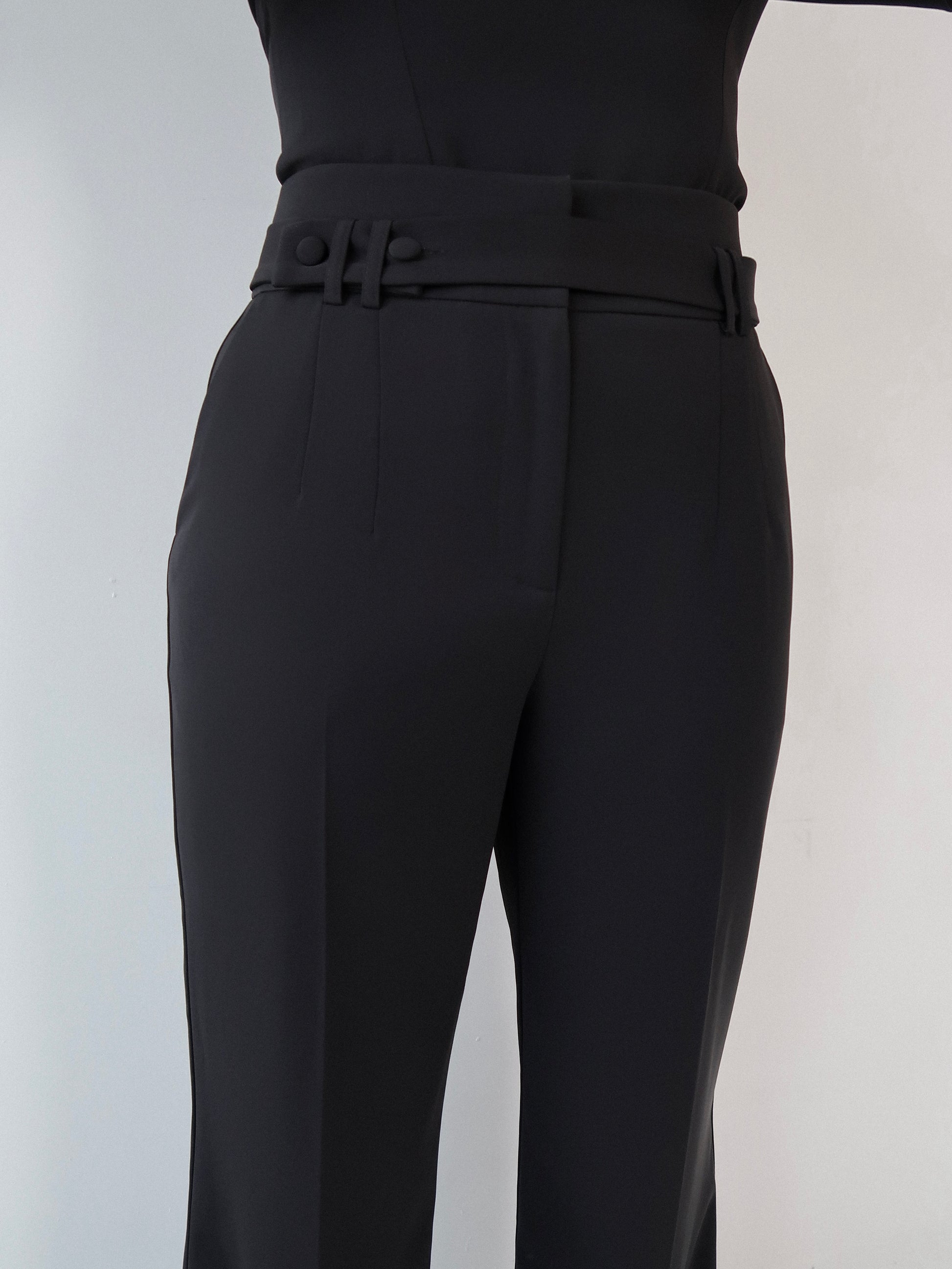 Close-up front view of black tailoring belted wide leg trousers in Classic Noire by Ardore London, showcasing the high-waist belt detail, premium fabric texture, and expert tailoring.