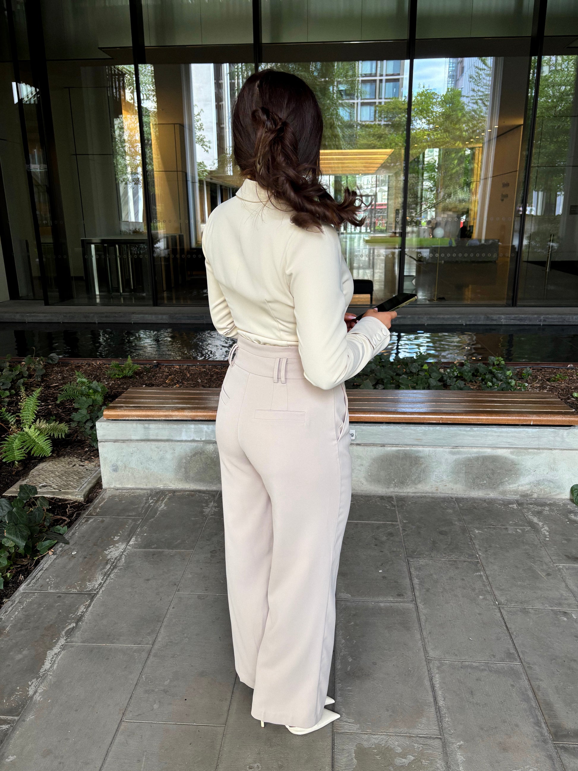 Close-up of tailoring wide leg trousers in chai latté by Ardore London, featuring elegant fabric texture and high-quality tailoring details.