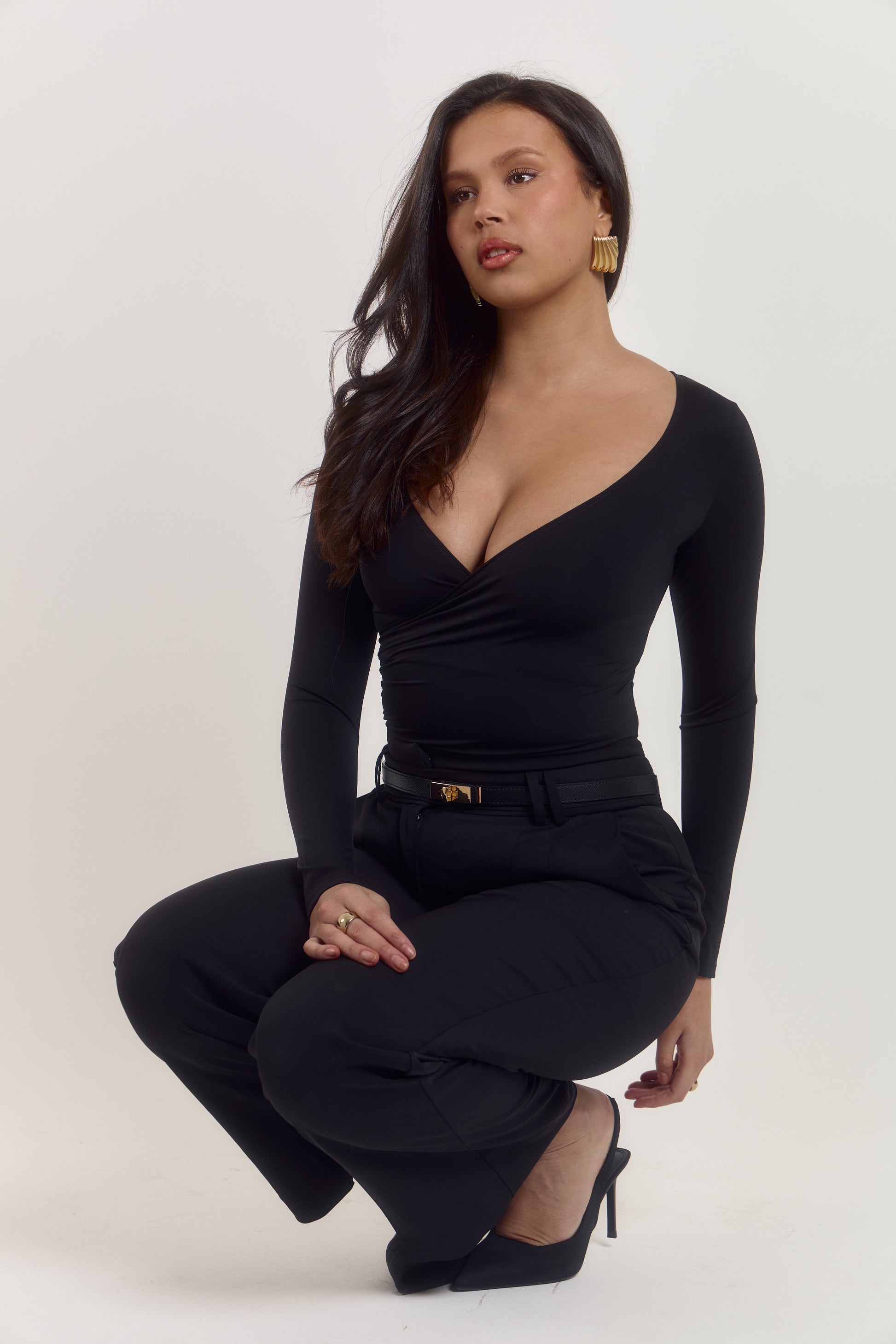 Tummy control black wrap bodysuit with elegant ruched front detail.