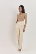 Neutral tan long sleeve cotton bodysuit with classic Henley neckline.