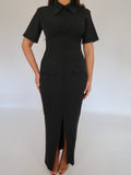 Close-up of Ardore London Classic Noire Sculpting Maxi Dress, featuring luxurious fabric, chic curved seams, and a structured collar. The partially non-functional buttons and hidden button add a refined, thoughtful detail to this elegant piece.