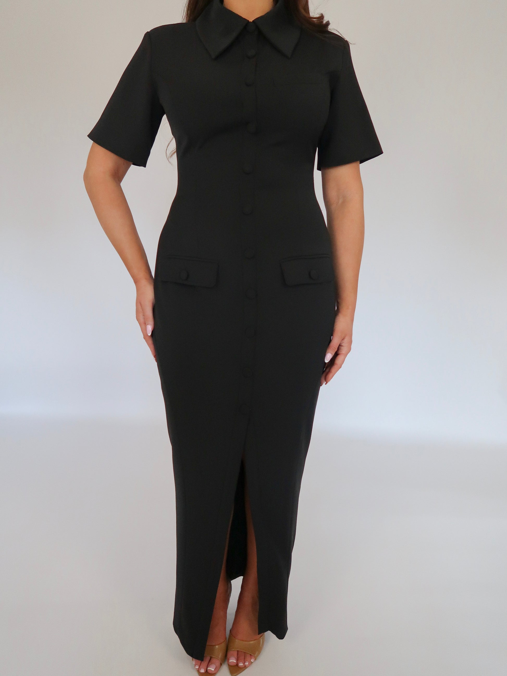 Close-up of Ardore London Classic Noire Sculpting Maxi Dress, featuring luxurious fabric, chic curved seams, and a structured collar. The partially non-functional buttons and hidden button add a refined, thoughtful detail to this elegant piece.