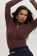 Premium cocoa brown cotton rib long sleeve bodysuit with refined minimal aesthetic.