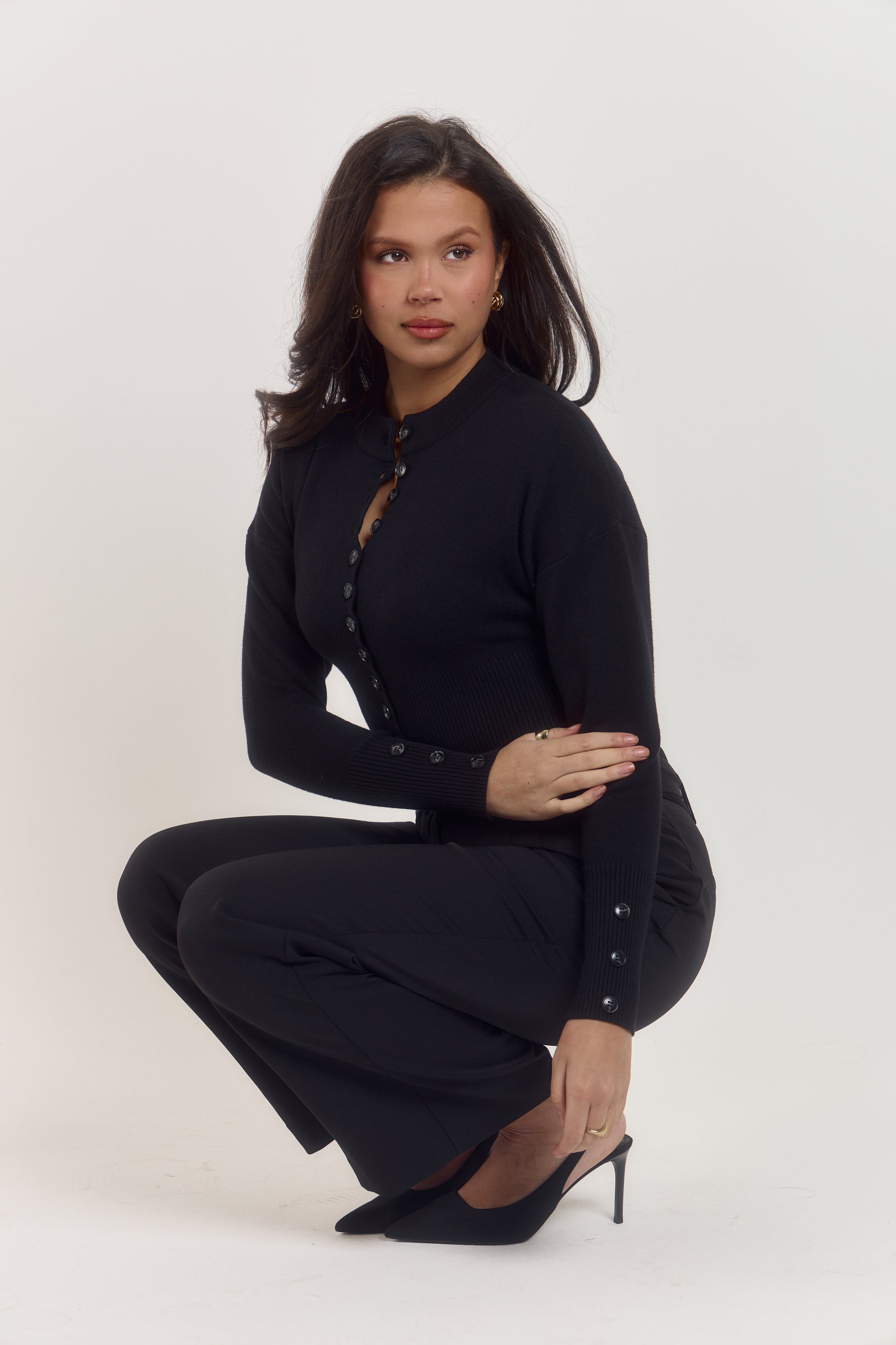 Structured women’s black cardigan with statement front buttons and softly tapered sleeves.