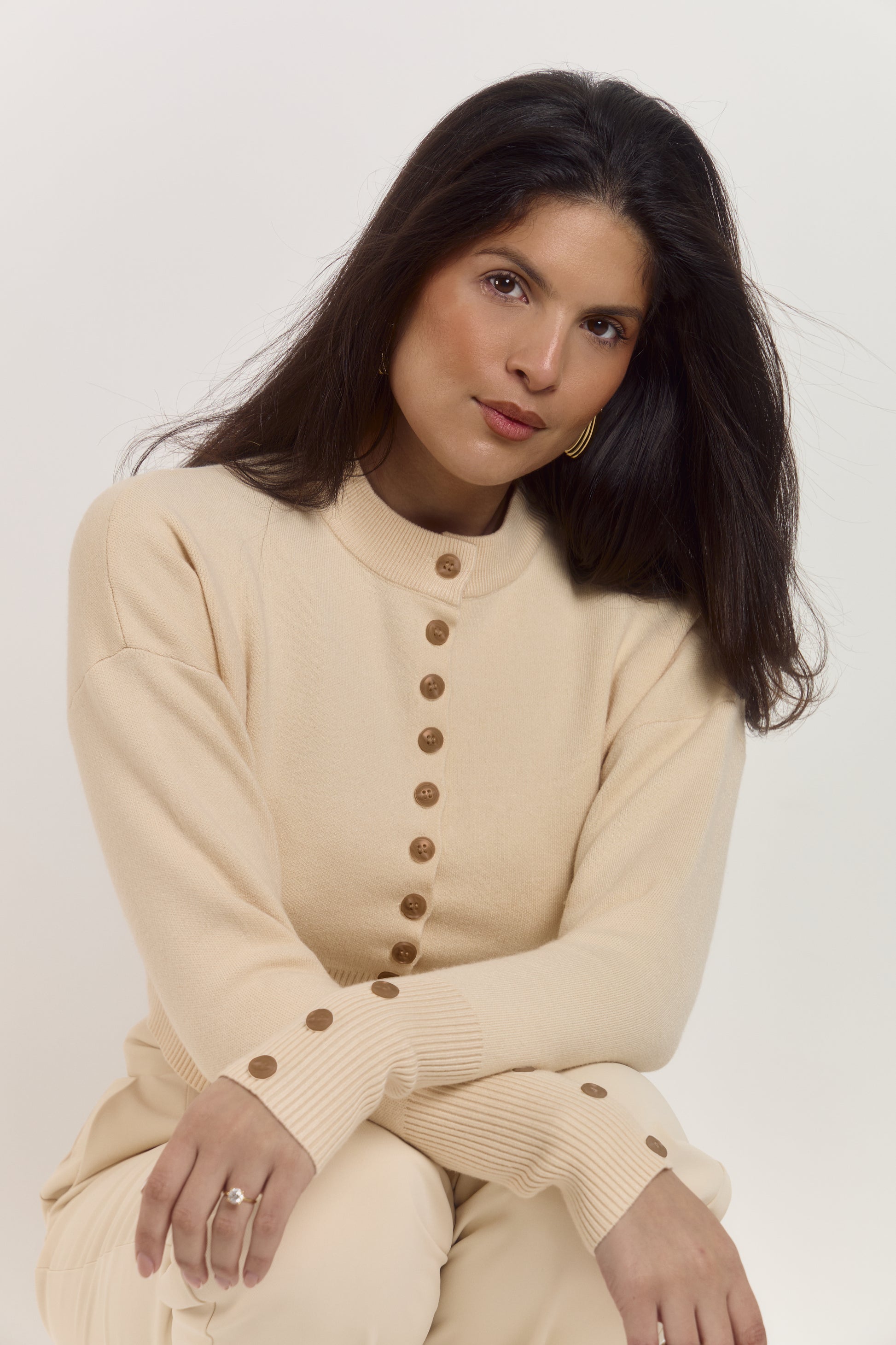 Fitted almond latte cardigan designed to sculpt the waist with contrast buttons and cosy knit fabric