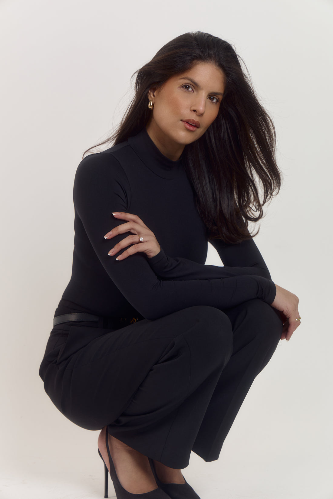 Black contour form shapewear bodysuit with smoothing midsection effect.