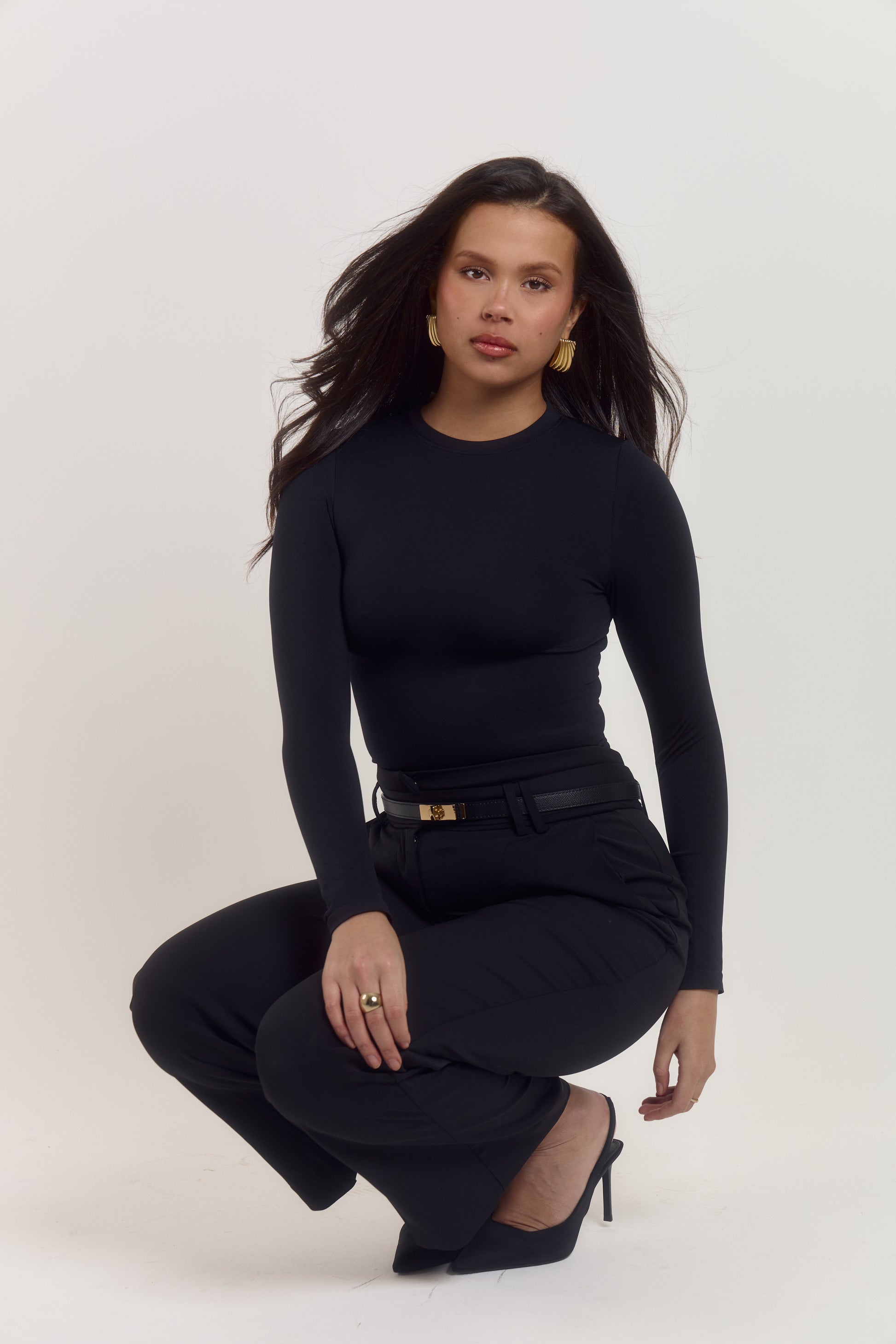 Luxury black compression bodysuit with four way stretch and streamlined silhouette definition.