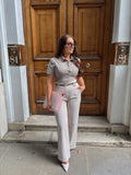 Tailoring belted wide leg trousers paired with a short sleeve buttoned sculpted top in taupe pinstripe by Ardore London, featuring a flattering sculpted fit and vintage-inspired design