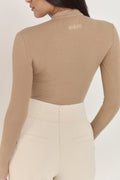 Flattering tan cotton rib Henley style bodysuit styled with tailored trousers.