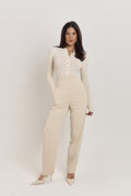 Vanilla Créme cotton ribbed long sleeve bodysuit with pearlised button front and fitted silhouette.
