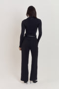 Long sleeve compression bodysuit in black with body contouring structure.