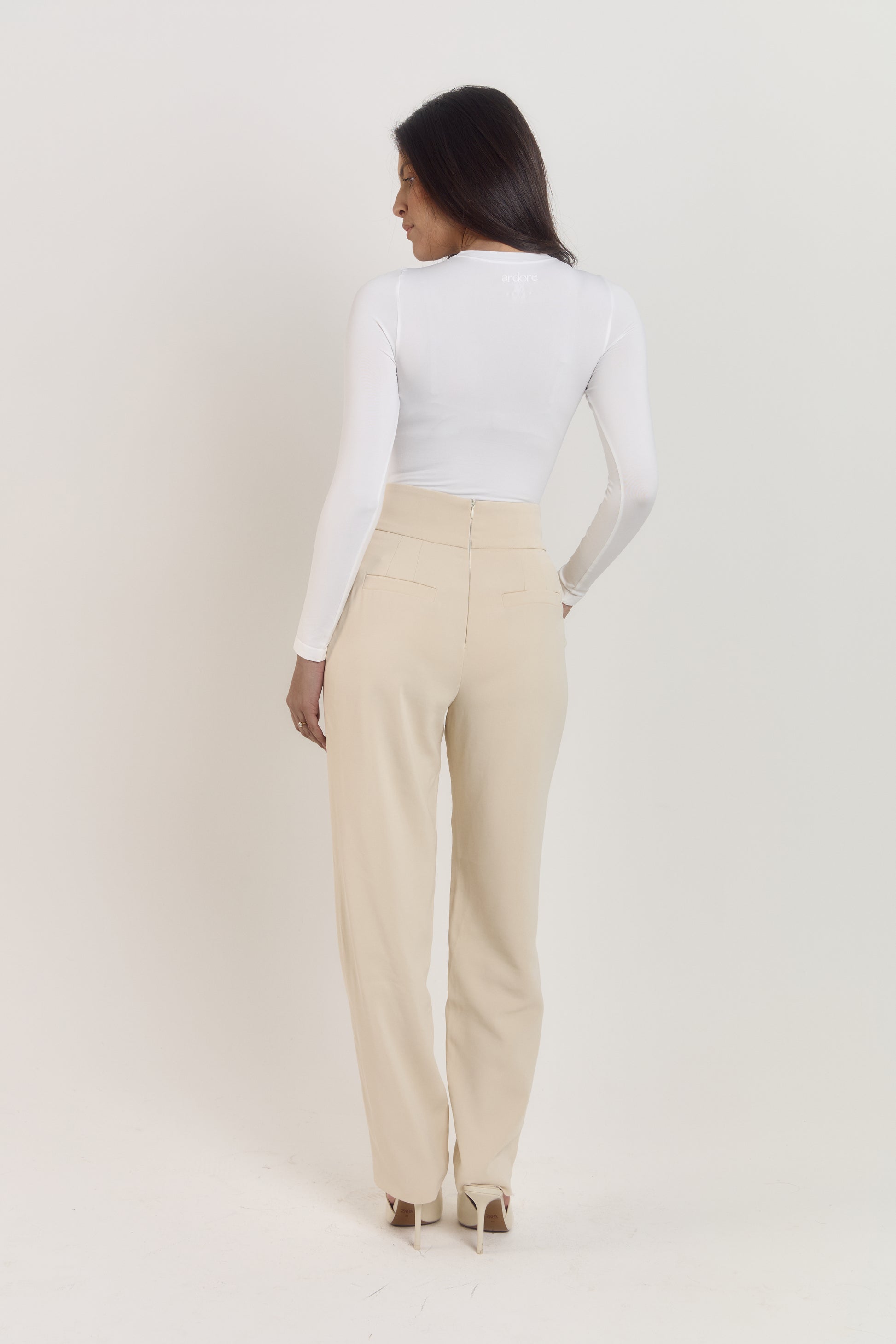 White long sleeve shapewear bodysuit with supportive sculpting fit.