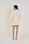 Ardore London Vanilla Crème structured long sleeve pleated mini dress, featuring precise tailoring, a textured fabric, and defined sleeve construction—an elegant, cozy choice for winter with its warm tones and full coverage silhouette.