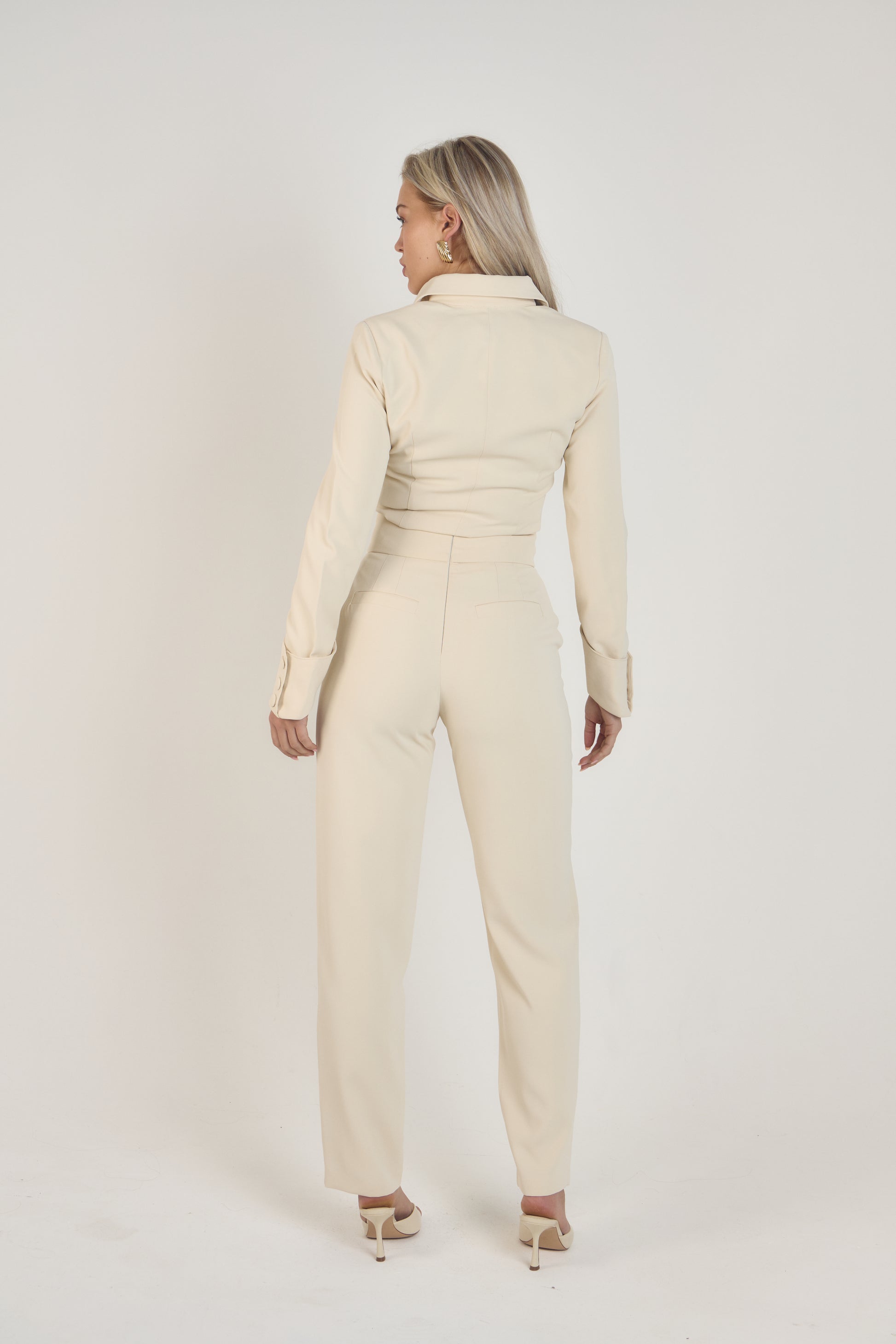Full view of Ardore London Vanilla Crème structured long sleeve sculpted blouse paired with cream trousers, offering a chic city look with sculpted tailoring, signature triple-button cuffs, exaggerated collar, and luxurious fabric—perfect for office elegance and sophisticated day-to-night style.