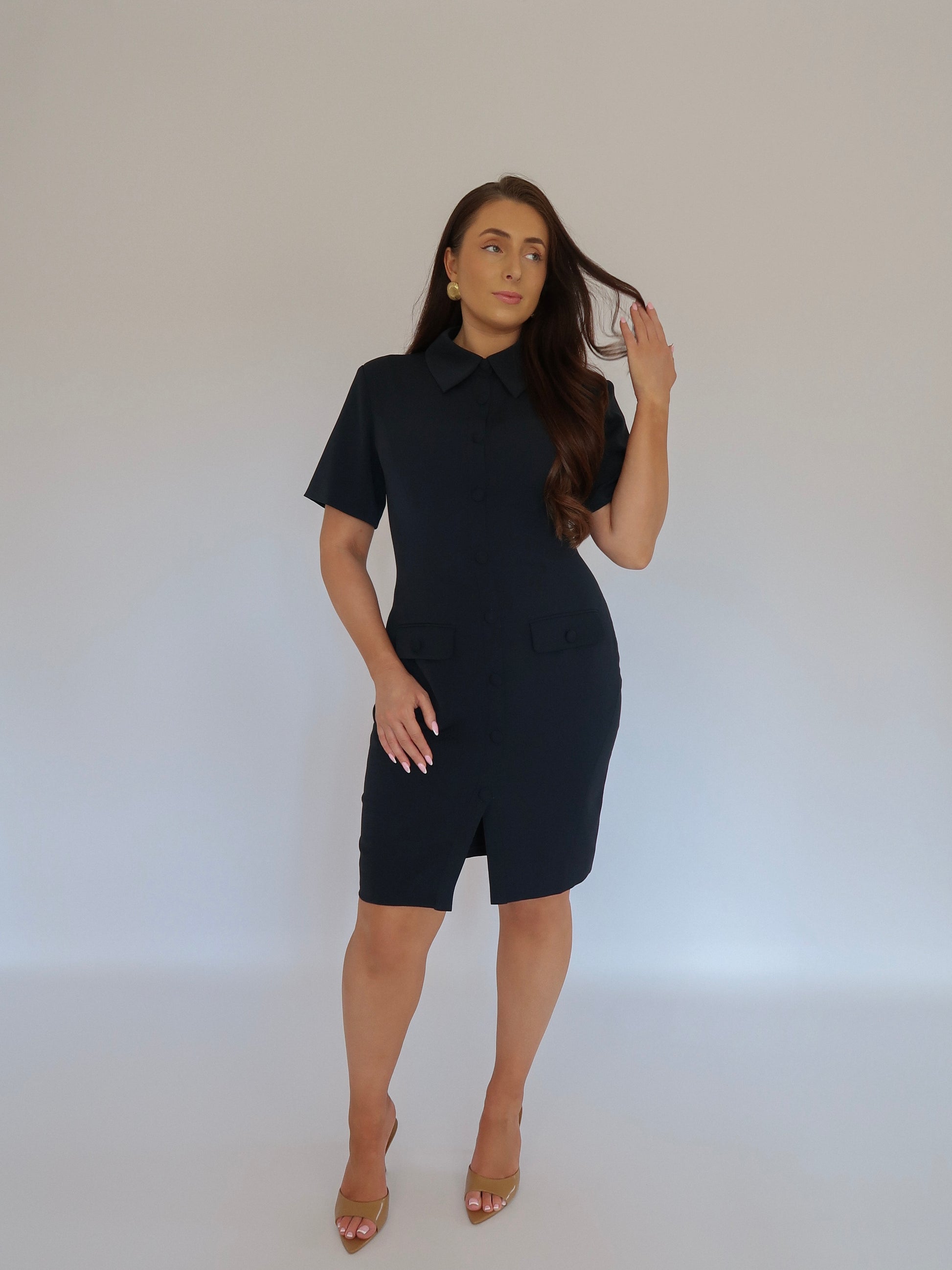 Full front view of Ardore London Sculpting Short Sleeve Buttoned Knee Length Dress in Midnight Bleu, offering a polished, office-ready look with flattering curved seams, structured collar, and functional pockets for a sleek, professional appearance.