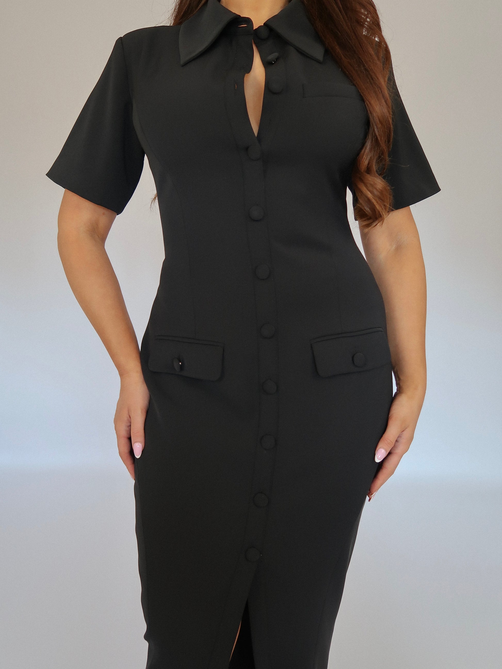 Close-up of Ardore London Classic Noire Sculpting Maxi Dress, featuring luxurious fabric, chic curved seams, and a structured collar. The partially non-functional buttons and hidden button add a refined, thoughtful detail to this elegant piece.