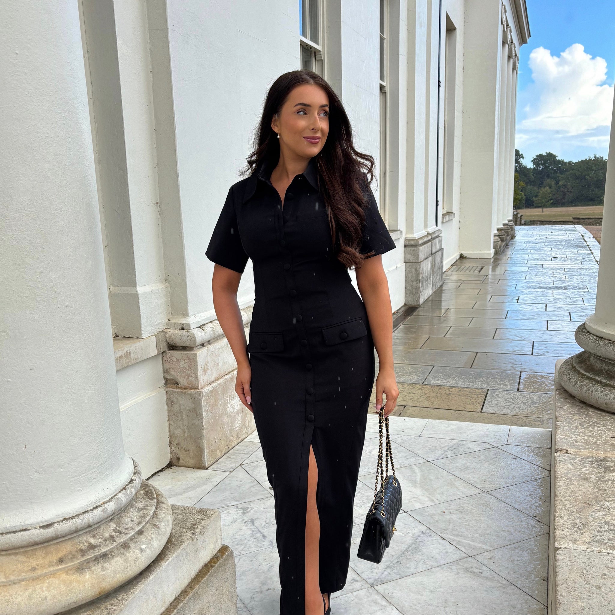 Full front view of Ardore London Sculpting Short Sleeve Buttoned Maxi Dress in Classic Noire, showcasing the chic, structured silhouette, signature curved seams, fabric-covered buttons, and exaggerated collar for a timeless, flattering look.