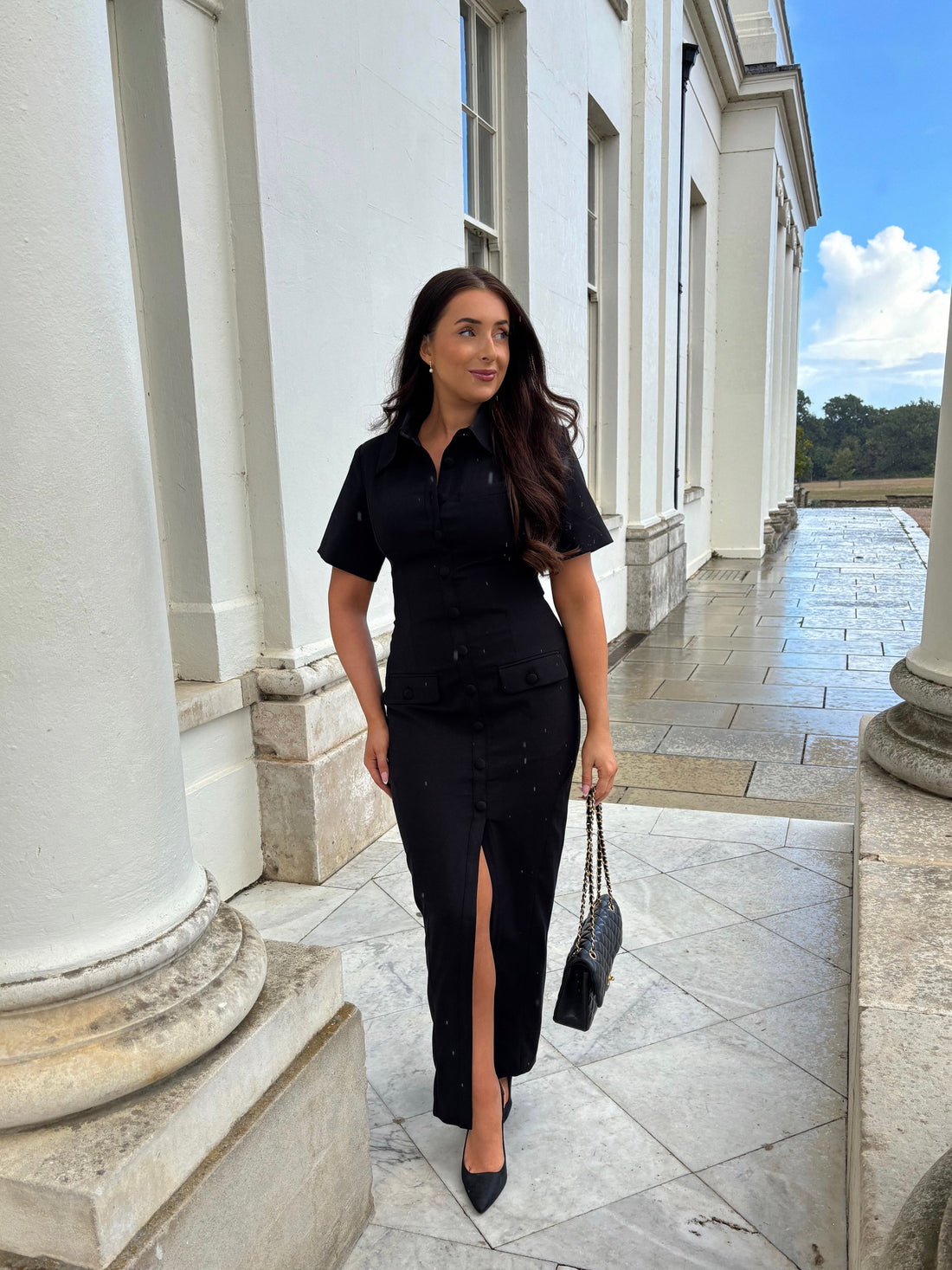 Full front view of Ardore London Sculpting Short Sleeve Buttoned Maxi Dress in Classic Noire, showcasing the chic, structured silhouette, signature curved seams, fabric-covered buttons, and exaggerated collar for a timeless, flattering look.
