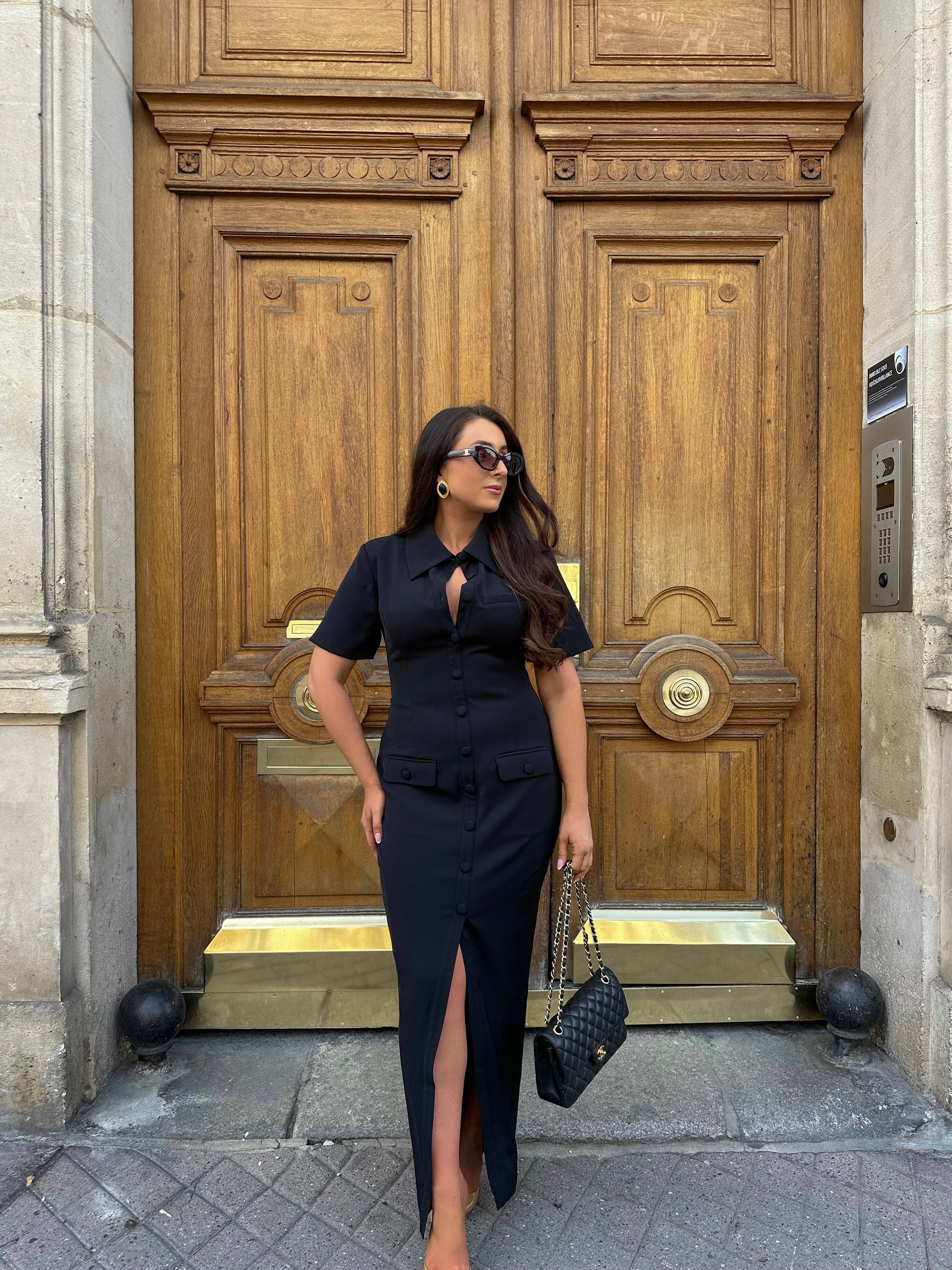 Full front view of Ardore London Sculpting Short Sleeve Buttoned Maxi Dress in Classic Noire, showcasing the chic, structured silhouette, signature curved seams, fabric-covered buttons, and exaggerated collar for a timeless, flattering look.