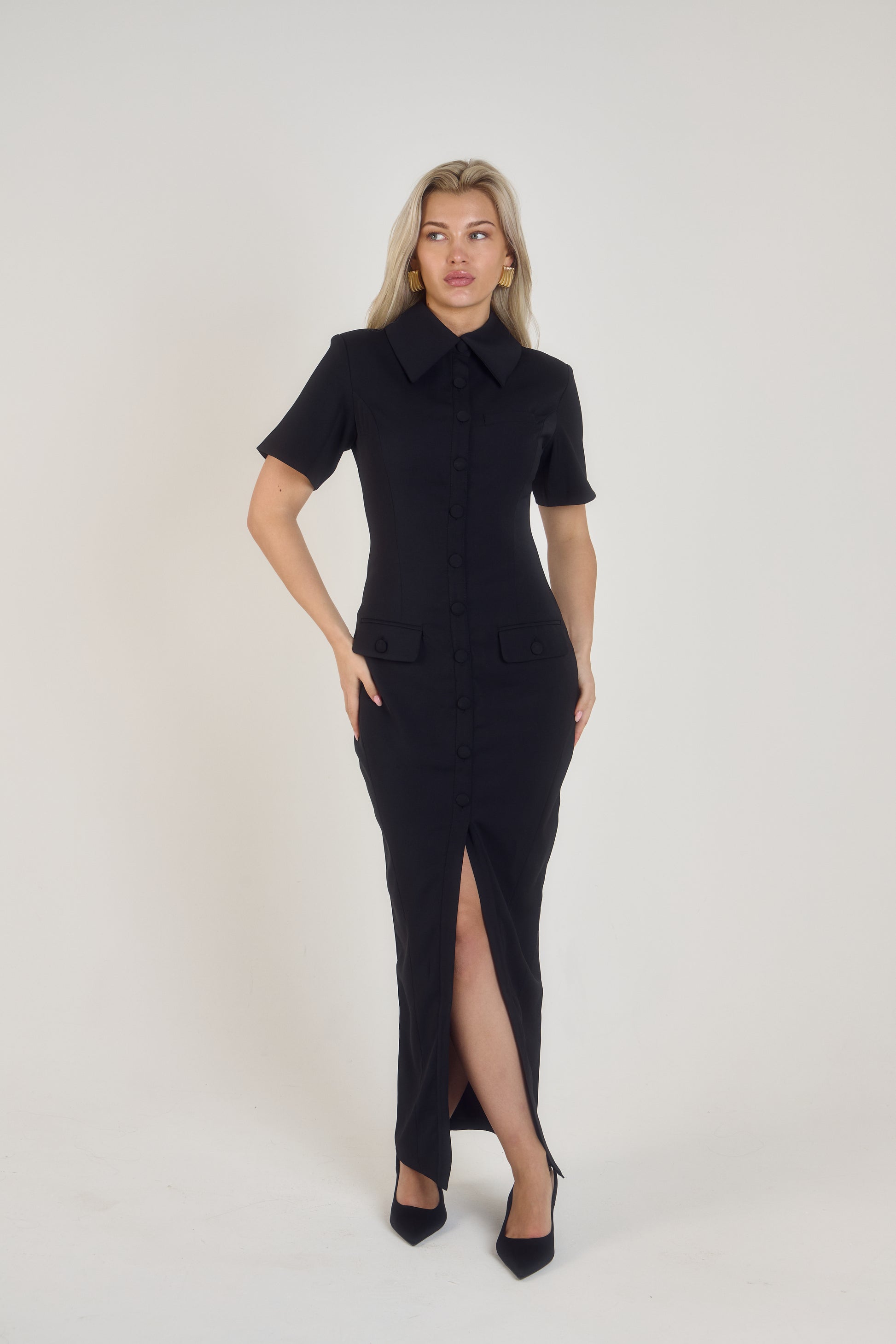 Full front view of Ardore London Sculpting Short Sleeve Buttoned Maxi Dress in Classic Noire, showcasing the chic, structured silhouette, signature curved seams, fabric-covered buttons, and exaggerated collar for a timeless, flattering look.