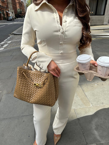 Close-up of Ardore London Vanilla Crème structured long sleeve sculpted blouse paired with cream trousers, featuring sculpted tailoring, signature triple-button cuffs, exaggerated collar, and soft, luxurious fabric for an elevated, chic look.