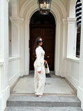 Side view of Ardore London Vanilla Crème structured long sleeve sculpted blouse paired with cream trousers, showcasing sculpted tailoring, signature triple-button cuffs, and an exaggerated collar for a polished, chic silhouette.