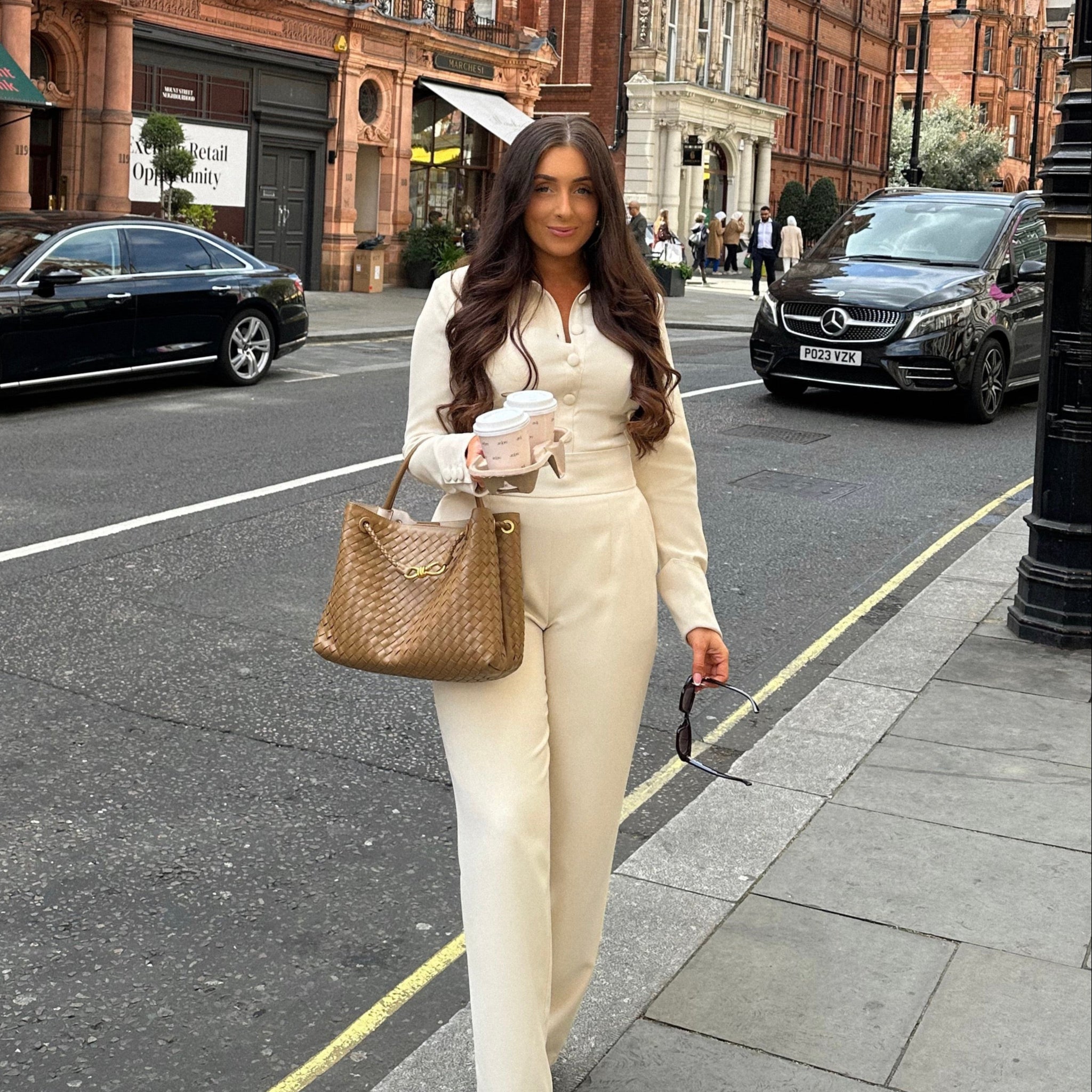 Full view of Ardore London Vanilla Crème structured long sleeve sculpted blouse paired with cream trousers, offering a chic city look with sculpted tailoring, signature triple-button cuffs, exaggerated collar, and luxurious fabric—perfect for office elegance and sophisticated day-to-night style.