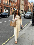 Full view of Ardore London Vanilla Crème structured long sleeve sculpted blouse paired with cream trousers, offering a chic city look with sculpted tailoring, signature triple-button cuffs, exaggerated collar, and luxurious fabric—perfect for office elegance and sophisticated day-to-night style.