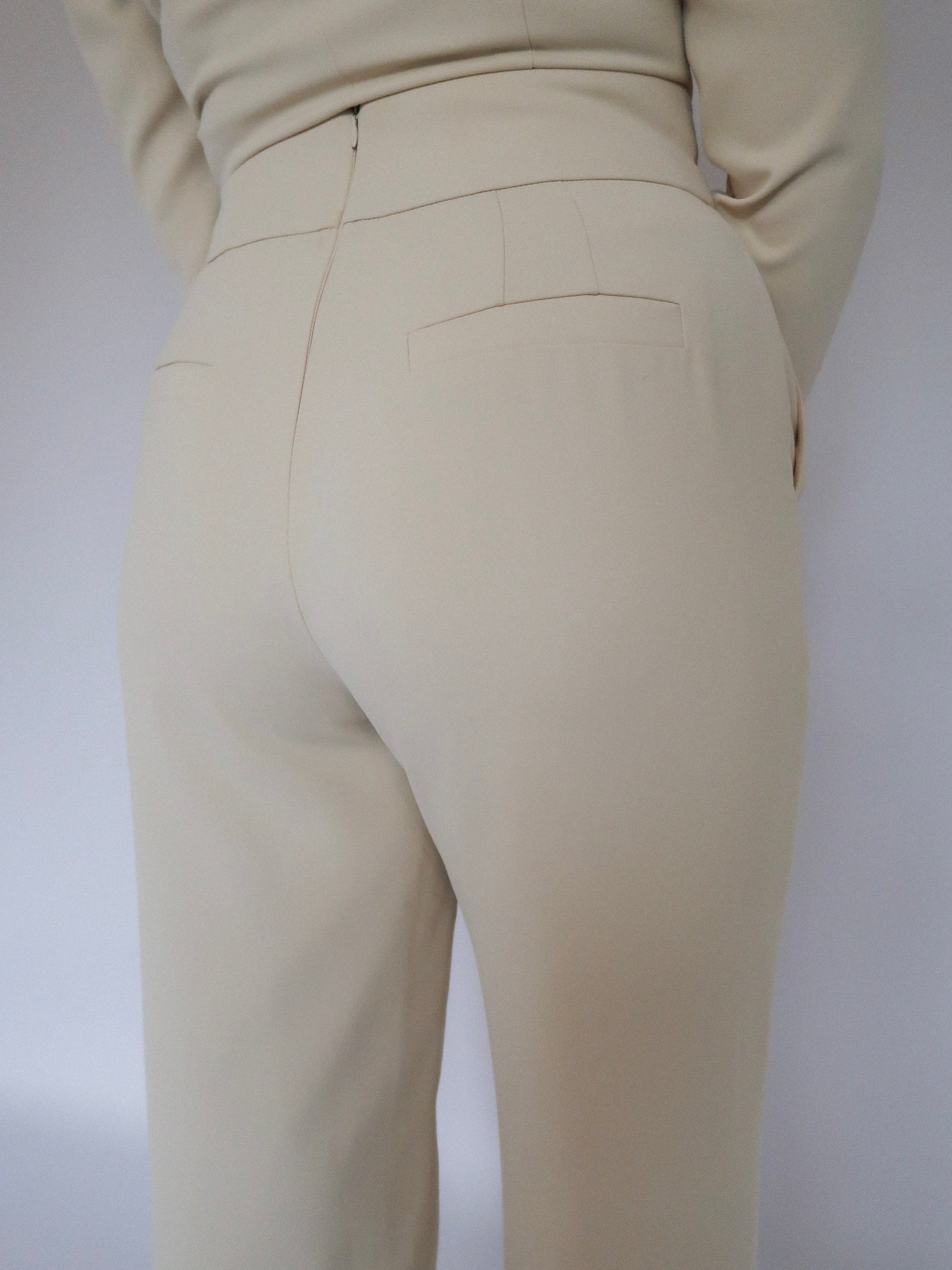 Back close-up of Ardore London Vanilla Crème high-waisted straight leg trousers, showcasing the sculpting fit, flattering high waist, and invisible back zip for a seamless, polished look.