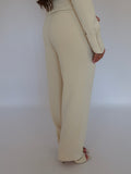 Side view of Ardore London Vanilla Crème high-waisted straight leg trousers, showcasing the sculpted silhouette, flattering high waist, and smooth, tailored fit for a chic and polished look.