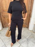 Styled front view of Ardore London’s Tailoring Sculpted High Neck Top in Classic Noire, paired effortlessly for a chic, polished look with wide sleeves and premium fabric