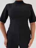 Styled front view of Ardore London’s Tailoring Sculpted High Neck Top in Classic Noire, paired effortlessly for a chic, polished look with wide sleeves and premium fabric