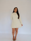 Full view of Ardore London Vanilla Crème structured long sleeve pleated mini dress featuring tailored silhouette, pleated skirt, and elegant long sleeves.