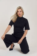 Front view of Ardore London’s Tailoring Sculpted High Neck Top in Classic Noire, featuring a flattering cinched fit, wide sleeves, and premium soft fabric