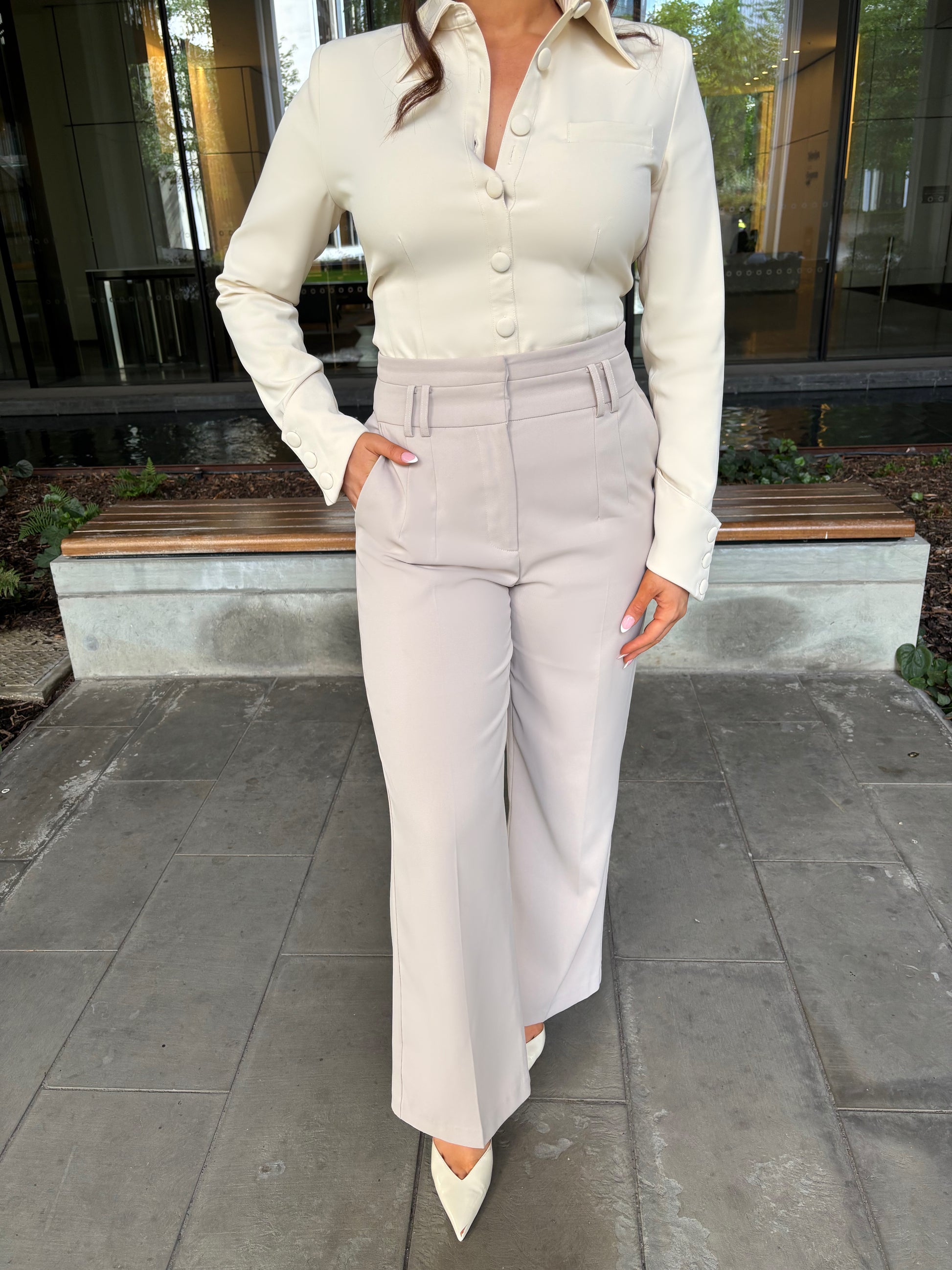 Close-up of Ardore London Vanilla Crème structured sculpted blouse, highlighting the sculpted fabric, signature triple-button cuffs, and exaggerated collar for a chic, polished look.